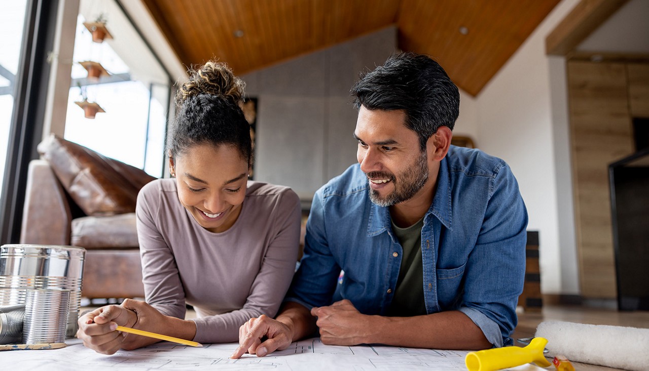 Young couple smiling and making plans