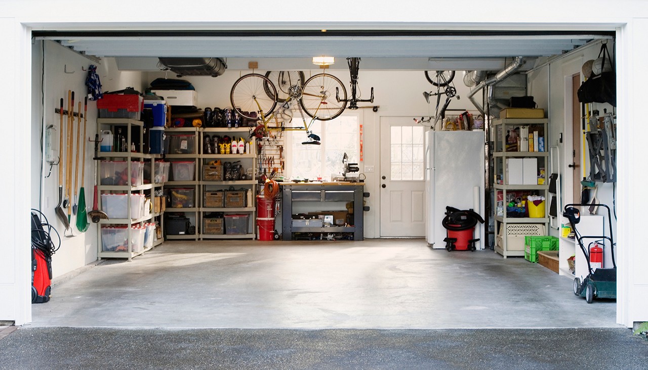 A very organized and clean garage with lots of items in containers and boxes.