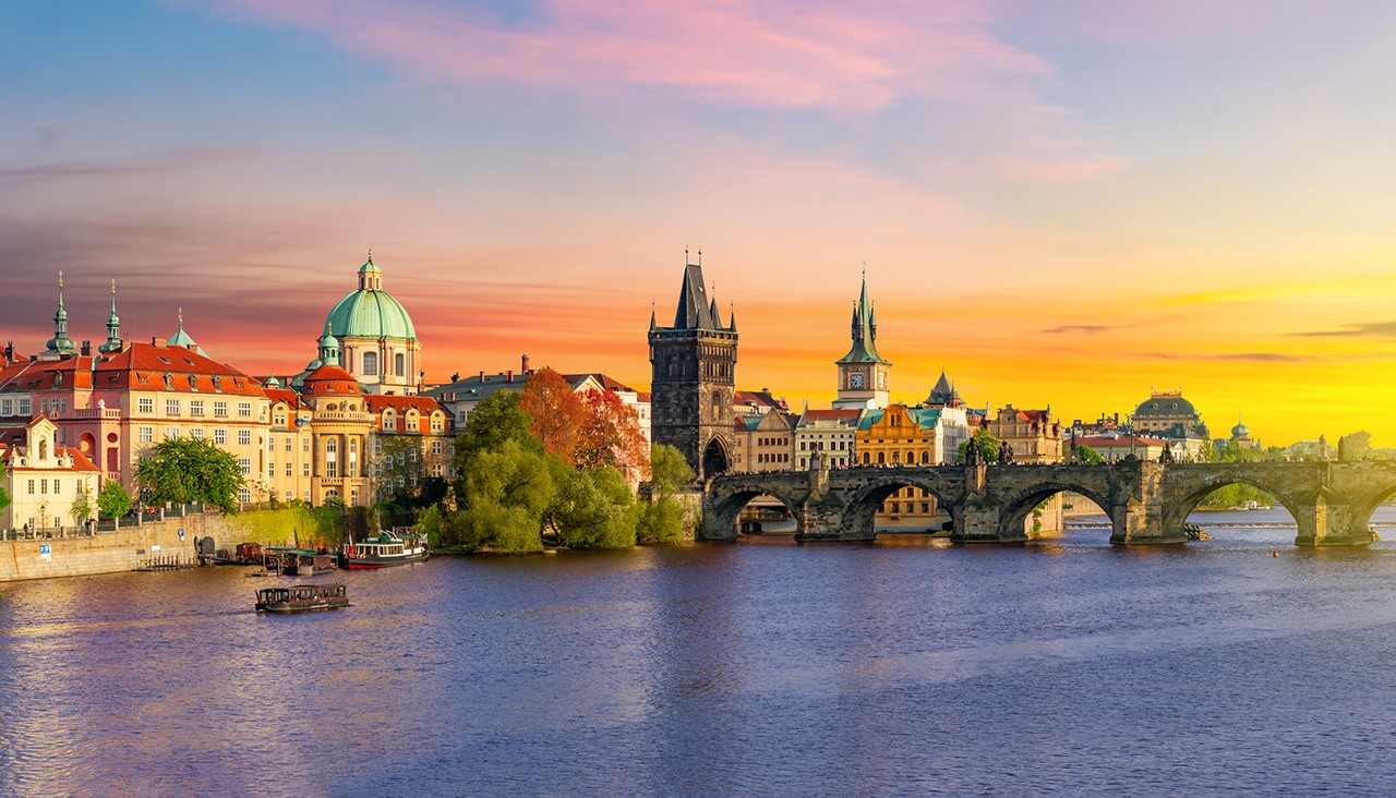 Classic Prague panorama with Old Town Bridge Tower and Charles bridge over Vltava river at sunset, Czech Republic