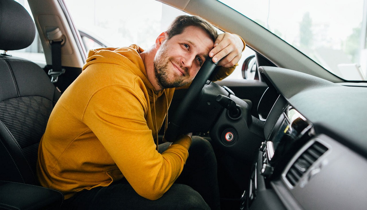 Man sits in his adored car.