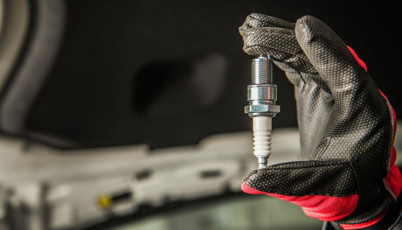 Vehicle Spark Plug in a Hand