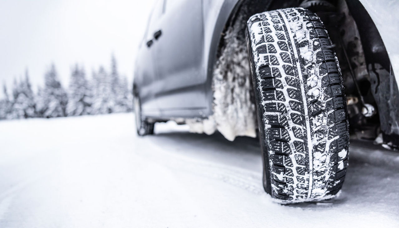 Car tire on a snowy road in winter