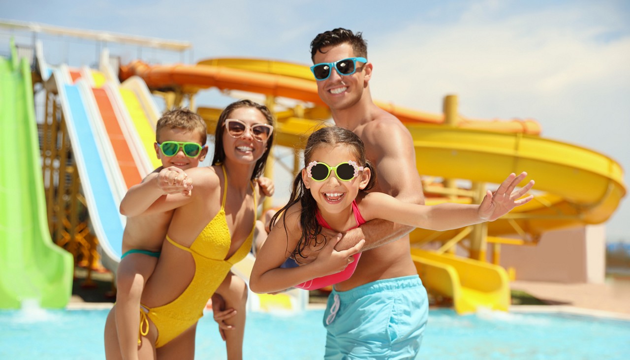 Happy family at water park. Summer vacation