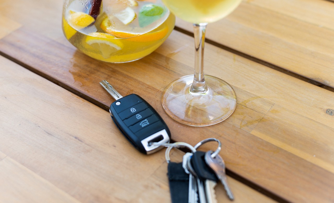 cocktail on a table next to set of car keys