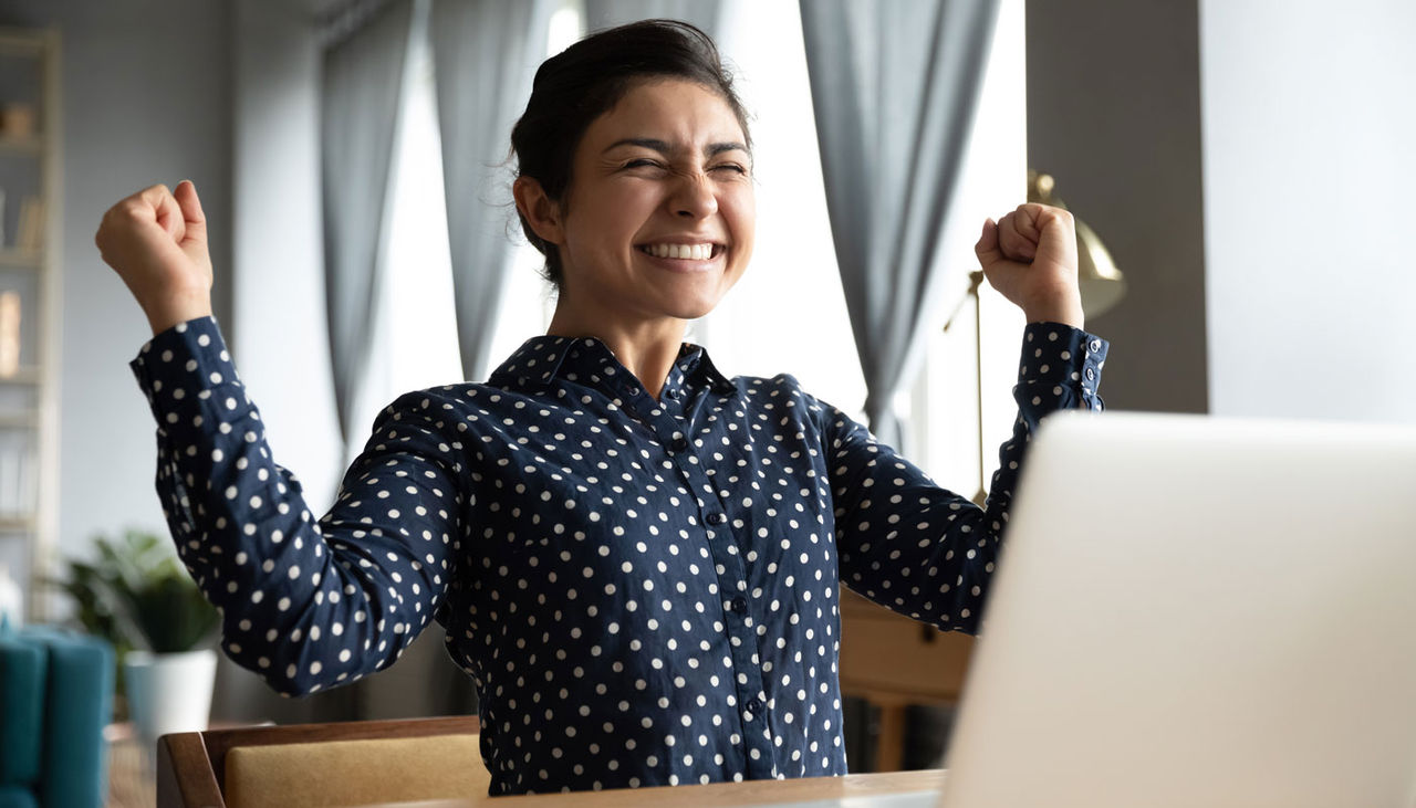 Smiling woman excited by good news, work success