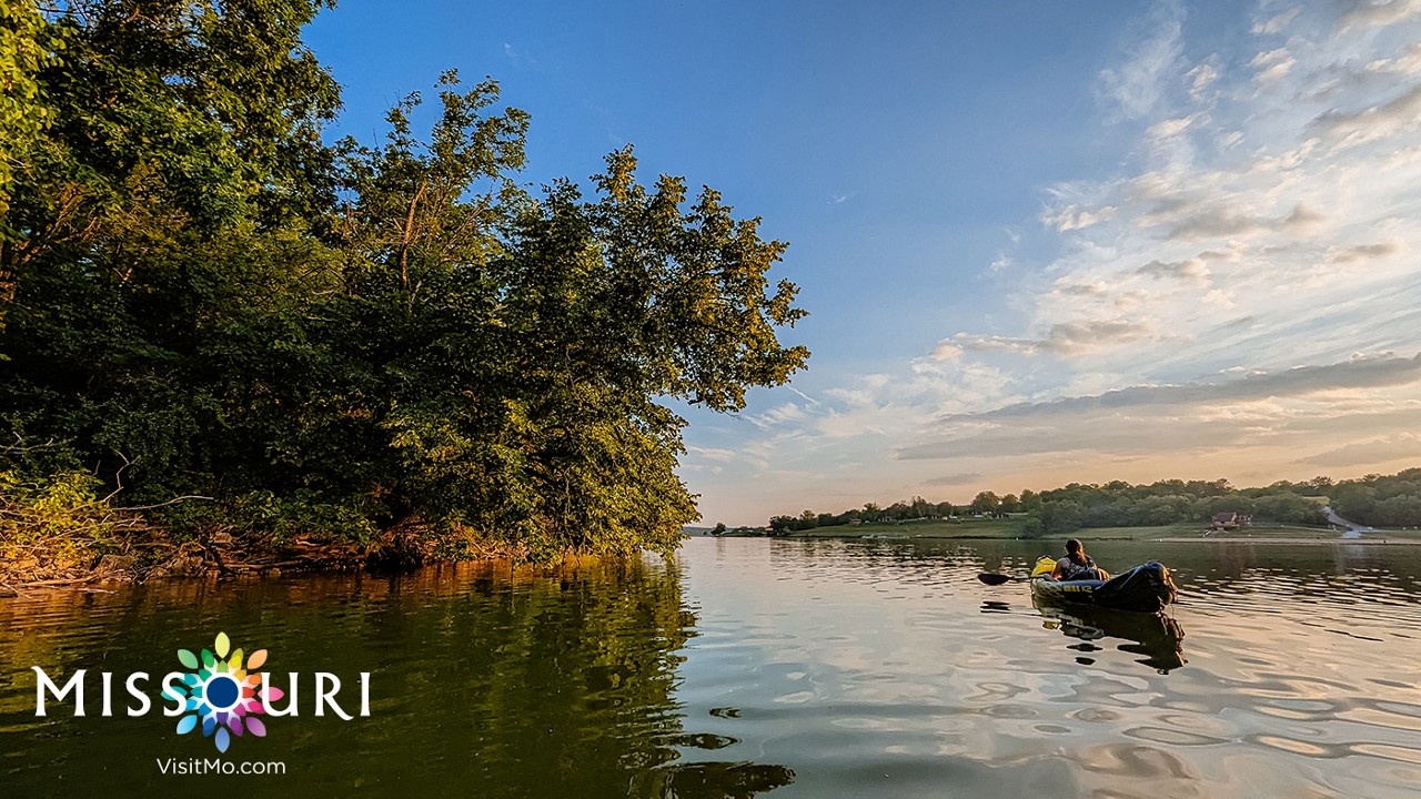 Kayaking Forest Lake by Brendon Wilson. Missouri. VisitMO.com logo.
