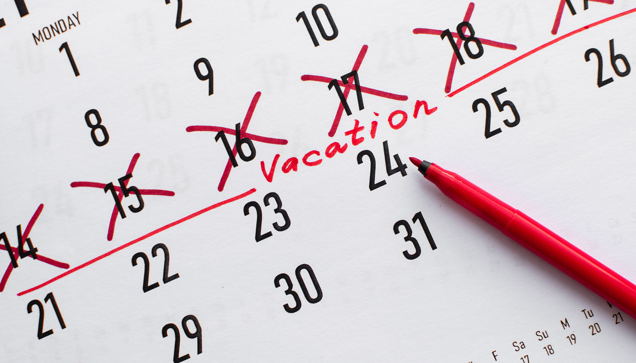 A calendar with dates checked off for vacation.