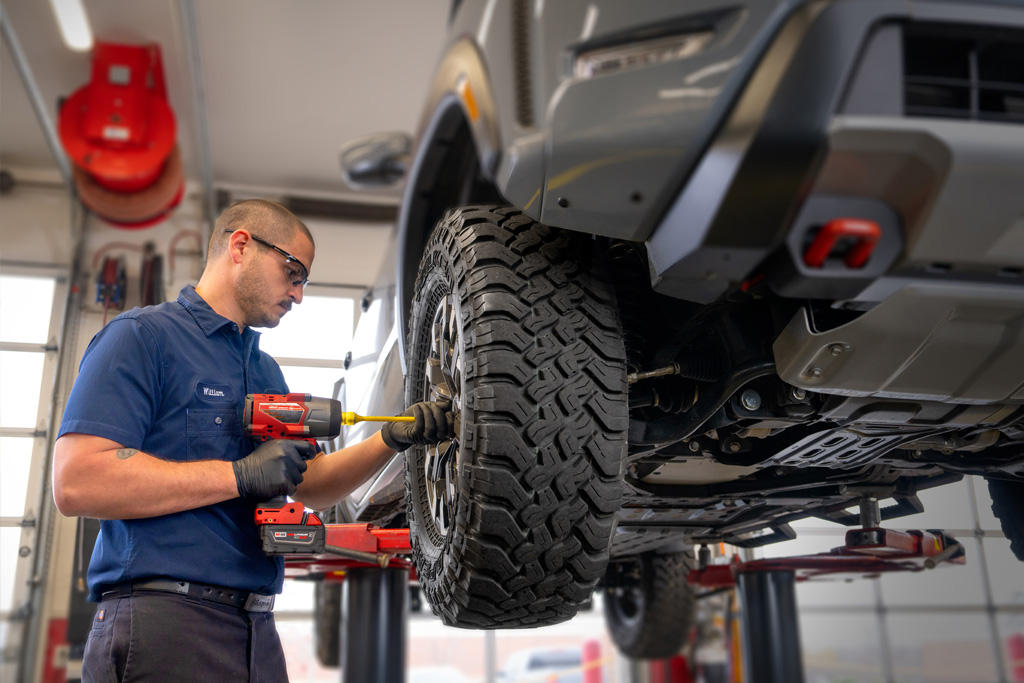 AAA auto repair tech removing a tire