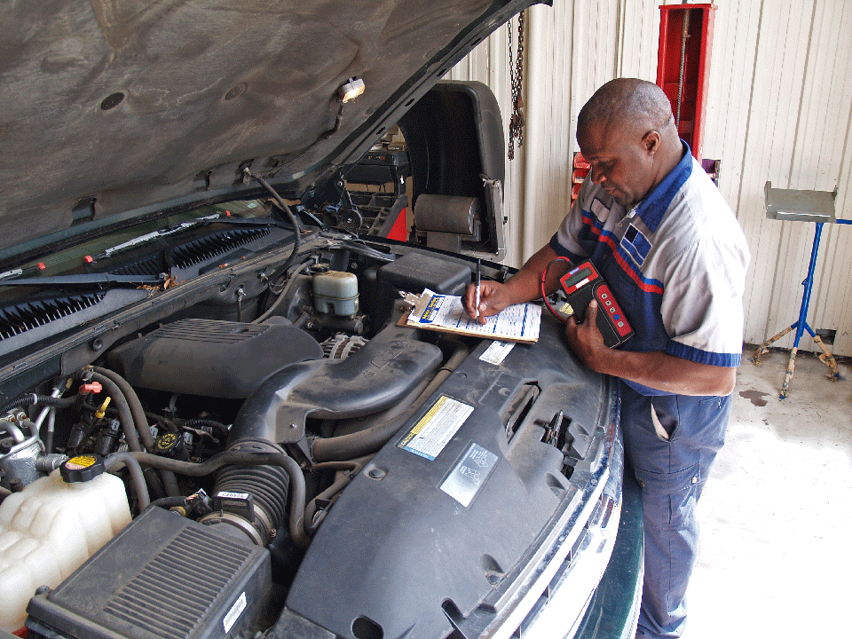 Auto mechanic performing routine inspection